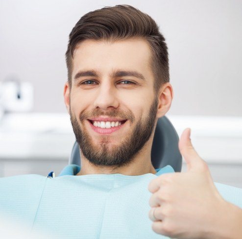Man giving thumbs up during dental office visit