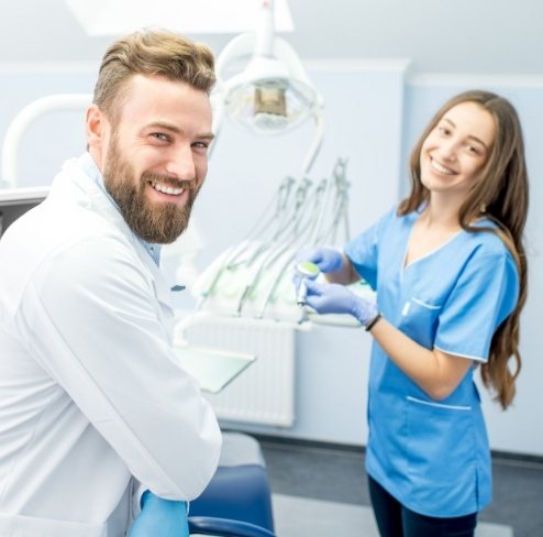 Two friendly dental team members in dental treatment room