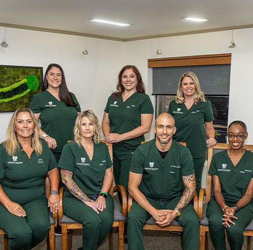 Two friendly dental team members in dental treatment room