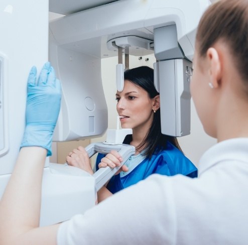 Woman receiving 3 D C T cone beam x-ray scans