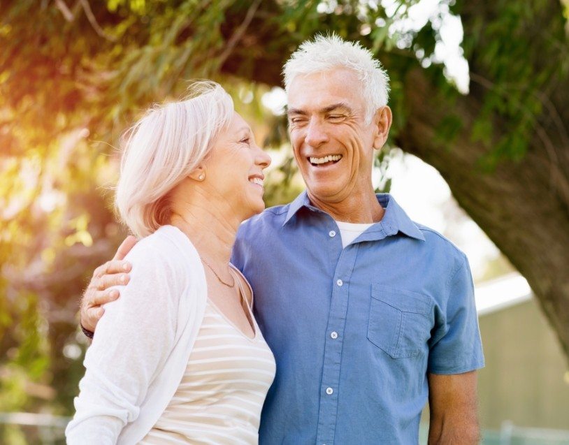 Man and woman with healthy smiles after restorative dentistry