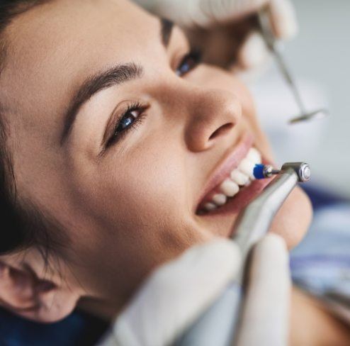 Patient receiving dental care to prevent cavities