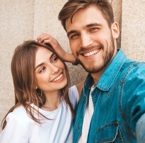 Man and woman smiling after preventive dentistry to freshen breath