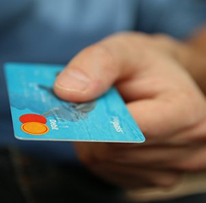 Man extending debit card for payment