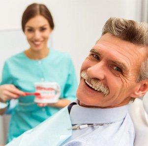 A handsome old man about to receive denture care