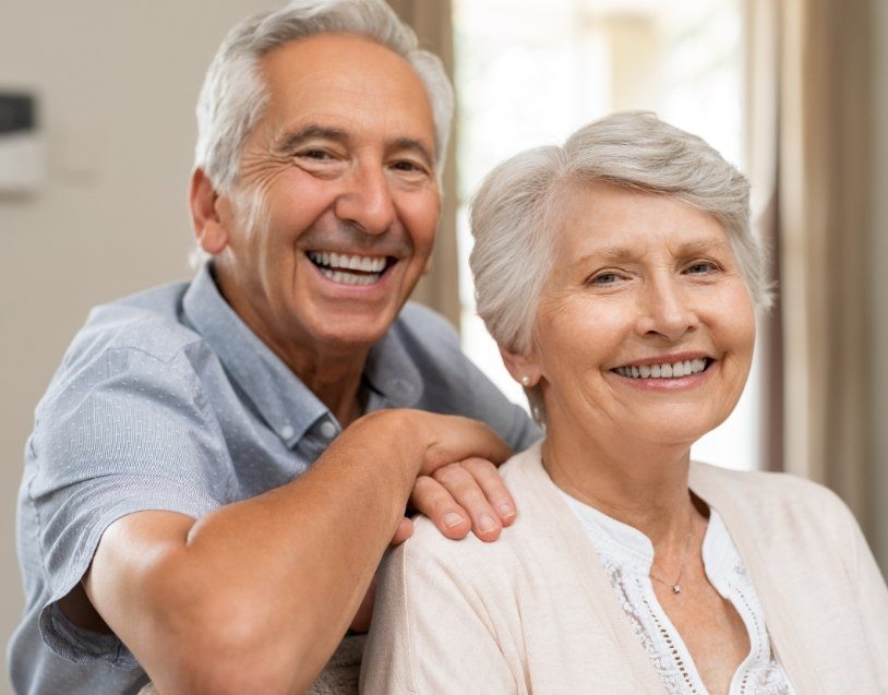 Man and woman with dentures smiling