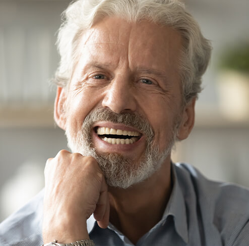 Man smiling after replacing ill filling dentures