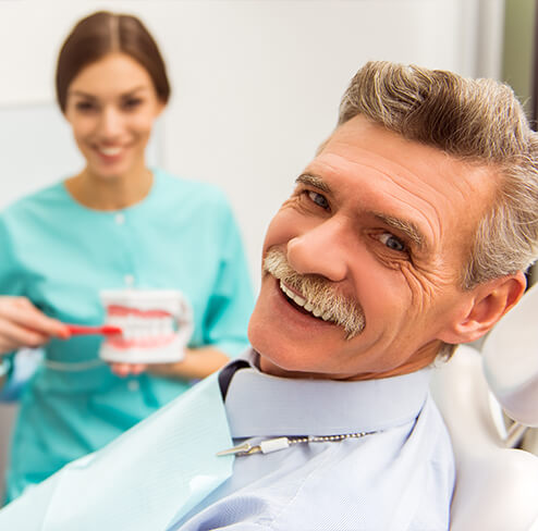 Man with dentures smiling