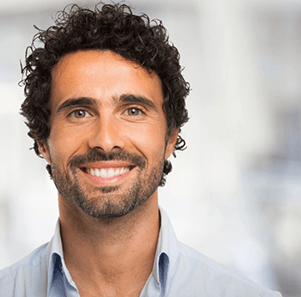 a man in Charlotte smiling with dentures