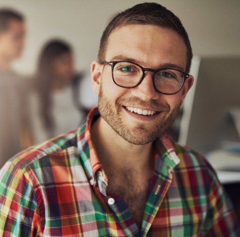 Man smiling after tooth extractions