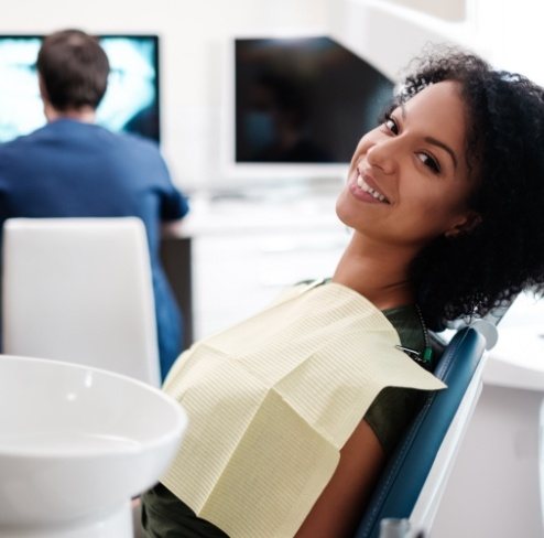 Woman smiling during tooth extraction visit