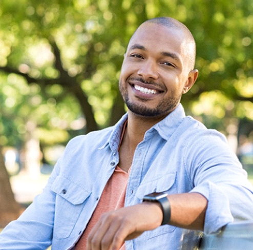 Man smiling outside looking at camera