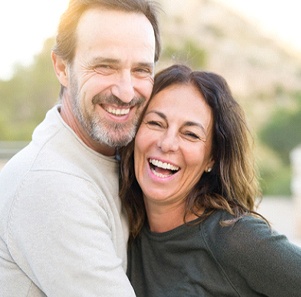 Couple smiling together outside