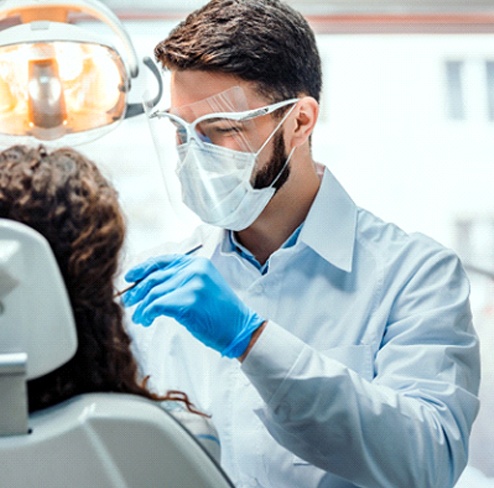 Implant dentist in Port Charlotte examining a patient