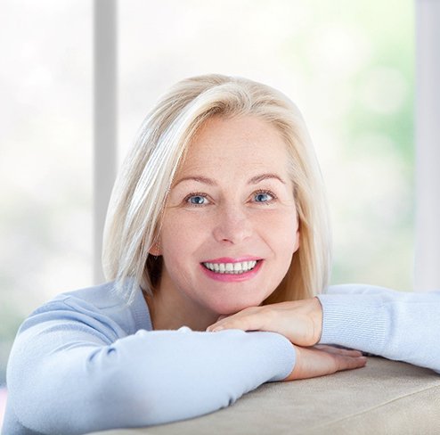 Happy, mature woman smiling with implant dentures in Port Charlotte