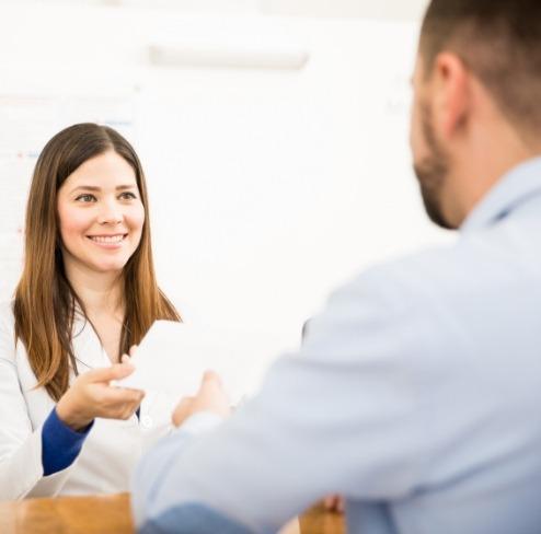 Dentist and patient discussing the cost of dental implants