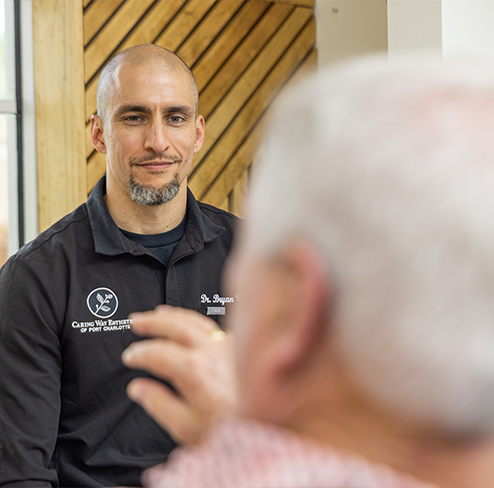 Doctor Villescas listening to a patient in the dental chair