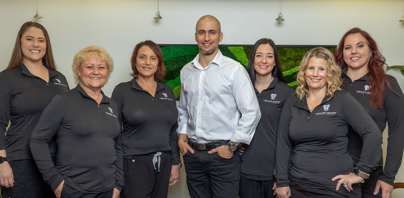 Dentists and dental team members smiling in Port Charlotte dental office