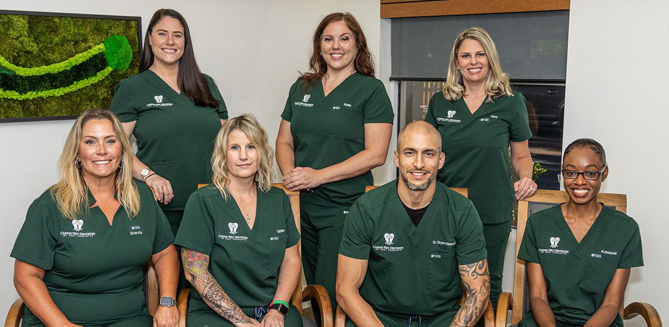 Dentists and dental team members smiling in Port Charlotte dental office