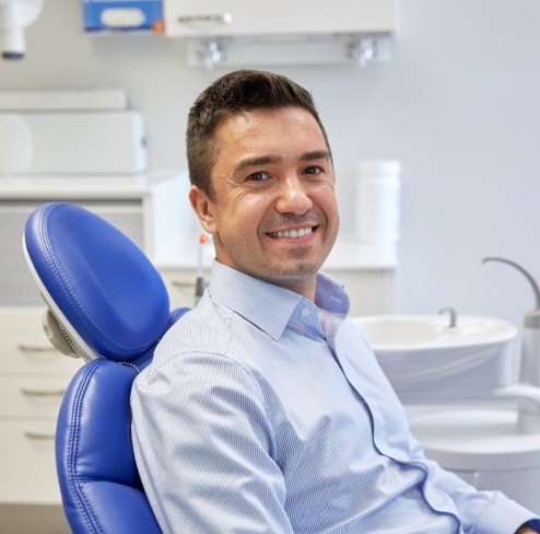 Man in dental chair smiling