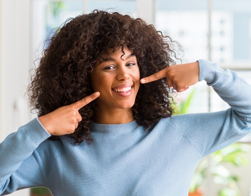 a patient smiling after receiving teeth whitening