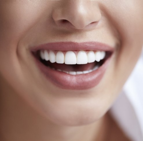 a patient smiling while visiting her dentist