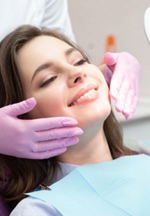 woman smiling in dental mirror 