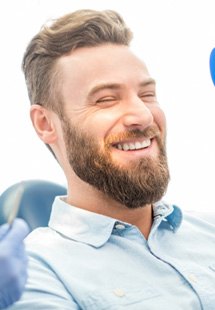 man smiling in dental mirror 