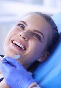 woman smiling while looking at dentist 