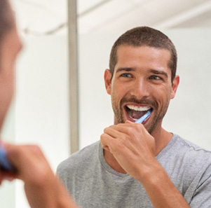 Patient in Port Charlotte brushing their dental implants