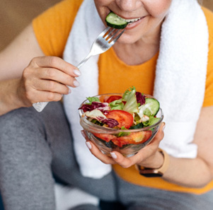Patient in Port Charlotte with dental implants eating healthy