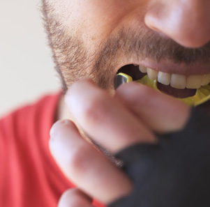 Patient in Port Charlotte wearing mouthguard to protect dental implants