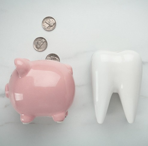 tooth and piggy bank for smile makeover in Port Charlotte