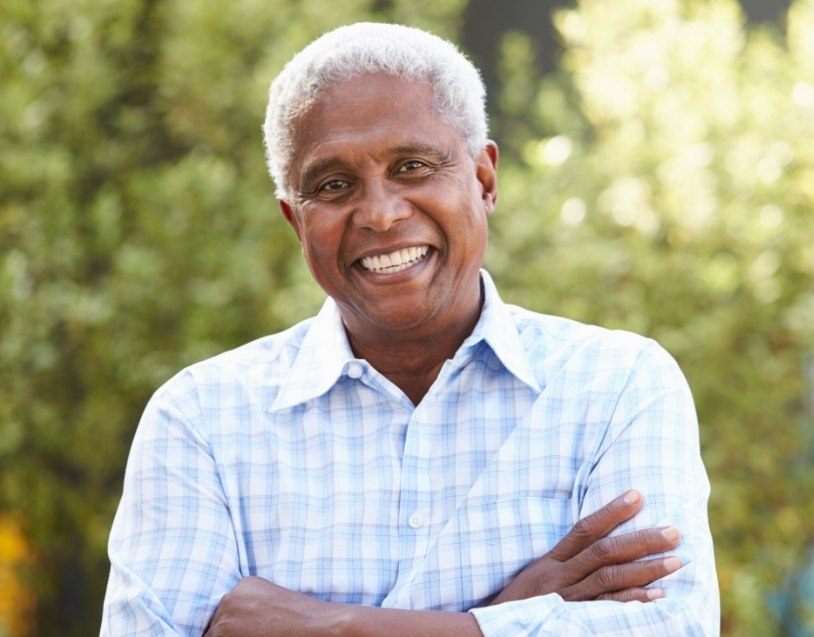 Man with healthy smile after replacing missing teeth