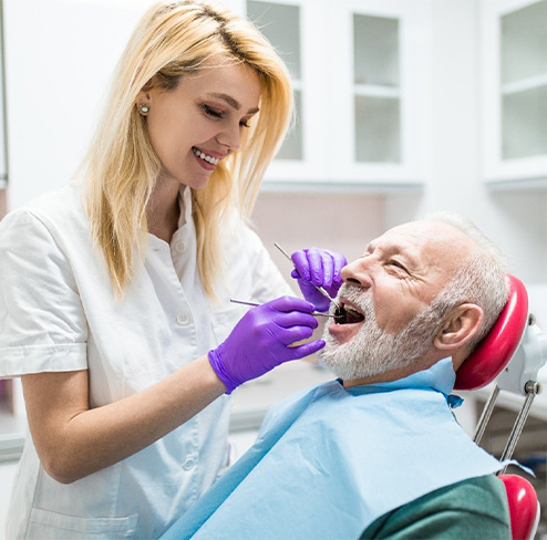 Man smiling after replacing ill filling dentures