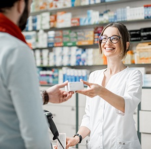 a person picking up a prescription from a pharmacy