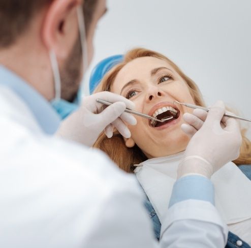 Woman receiving an oral cancer screening