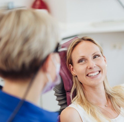 Woman discussing dental surgery with dentist