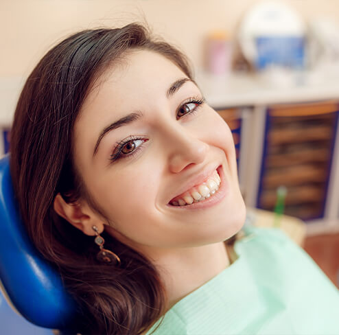 Woman sharing healthy smile after scaling and root planing