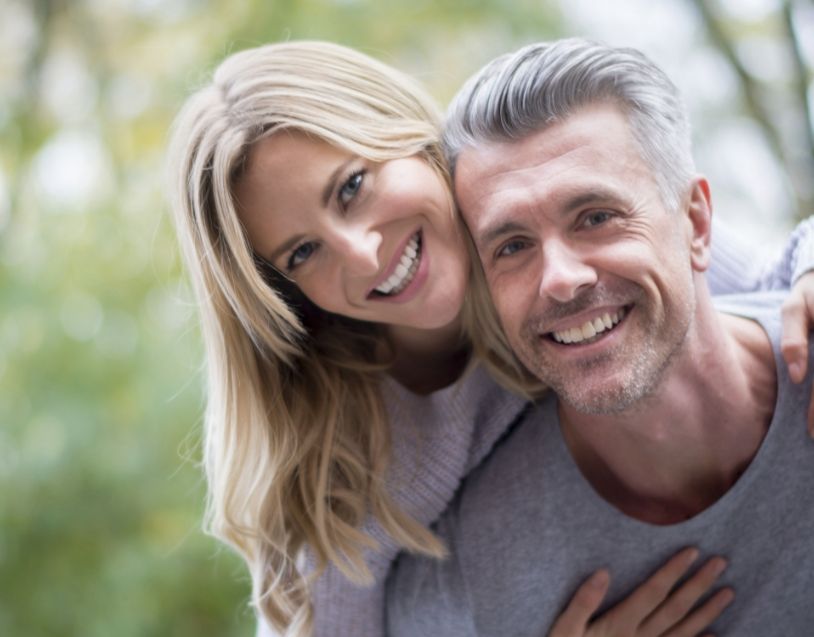 Man and woman with healthy smiles after preventive dentistry