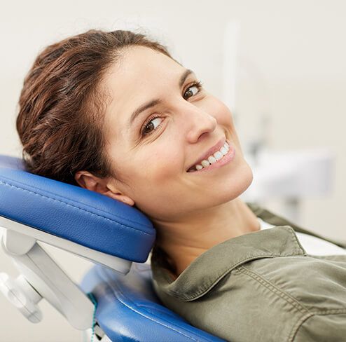 Woman smiling during dental checkup and teeth cleaning visit