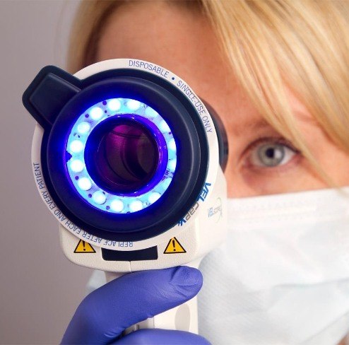 Dentist performing an oral cancer screening