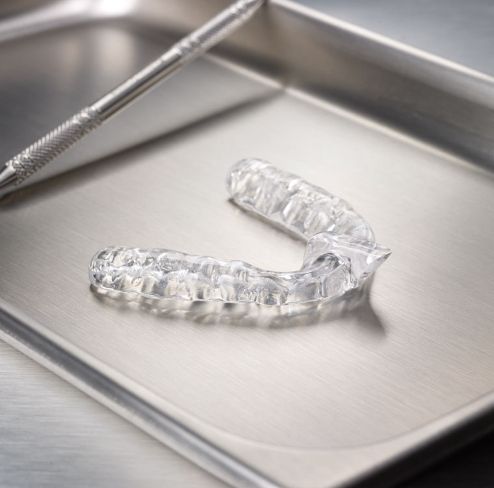 Clear nightguard for bruxism on metal tray