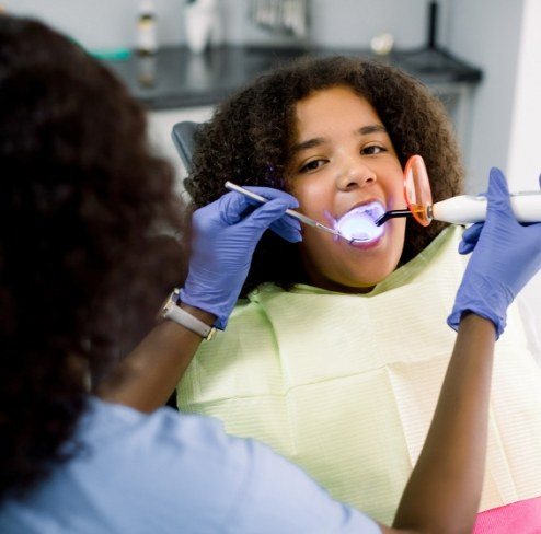 Patient receiving dental sealants