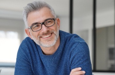 Man smiling and feeling rested thanks to sleep apnea therapy