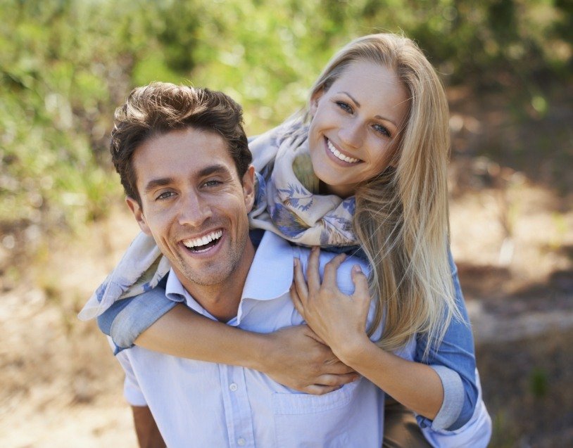 Man and woman smiling after visiting the dentist