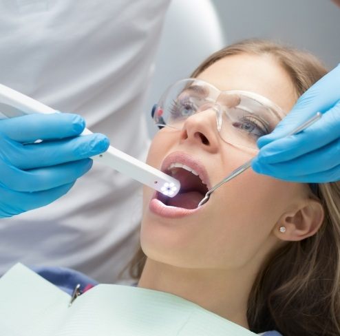 Dentist using intraoral camera to capture smile photos