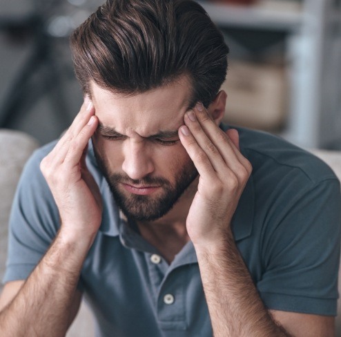 Man with headache due to T M J dysfunction