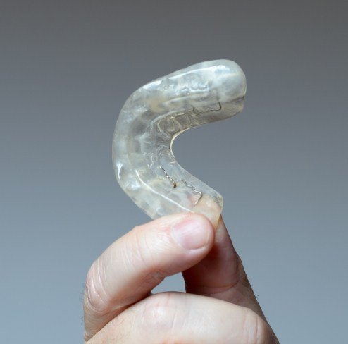 Hand holding an occlusal splint