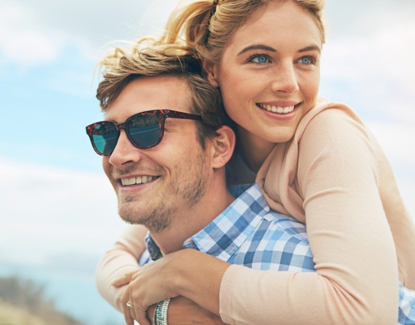 Man and woman with healthy smiles after tooth-colored fillings